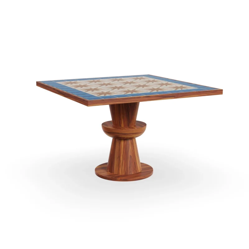 Vedrà dining table by Mediterrazza in iroko wood, featuring a sculptural base and a ceramic top with a radiant sun motif.