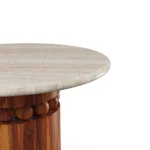 Bonifacio table by Mediterrazza, travertine side table with solid iroko wood base featuring detailed carved elements and refined artistry.