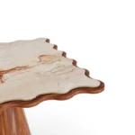 Top-down perspective of the Cagliari table, revealing the unique organic patterns and rich tones of the inlaid Aegean Rose marble surface.