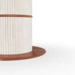 Close-up of the Escalet base, focusing on the rhythmic, ribbed texture of the travertine stone and its seamless connection to the tabletop.