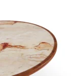 Detailed view of the circular Aegean Rose marble inlay, highlighting its unique stone patterns and the smooth iroko wood border.