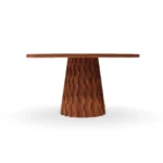 A forward view of the Fuengirola table, showcasing the organic relief patterns on the wooden base and the natural pink tones of the marble.