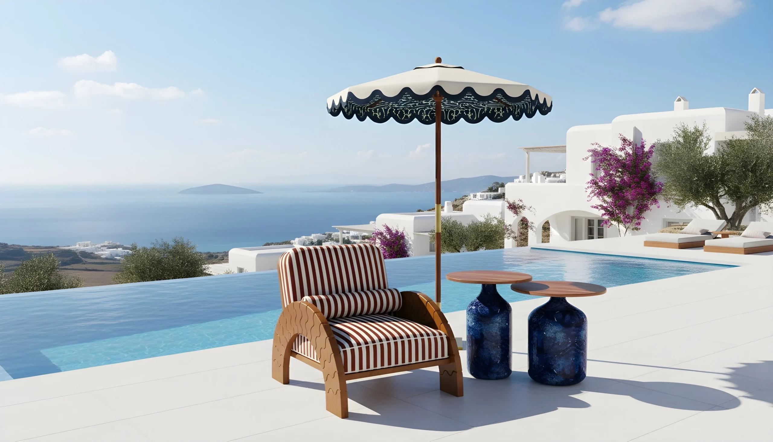 Luna armchair by Mediterrazza styled by an infinity pool overlooking the Aegean Sea, with a striped cushion, sculptural tables, and a Mediterranean parasol.