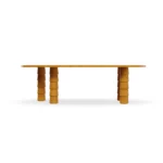 A direct look at the Macarella table, showcasing its bold architectural silhouette and the natural warmth of its handcrafted wooden frame