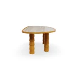 Side profile of the Macarella dining table, highlighting the elegant curvature of the carved legs and its refined outdoor design.