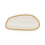 Top-down view of the Macarella table, revealing the unique organic shaping and porous texture of the inlaid travertine surface.