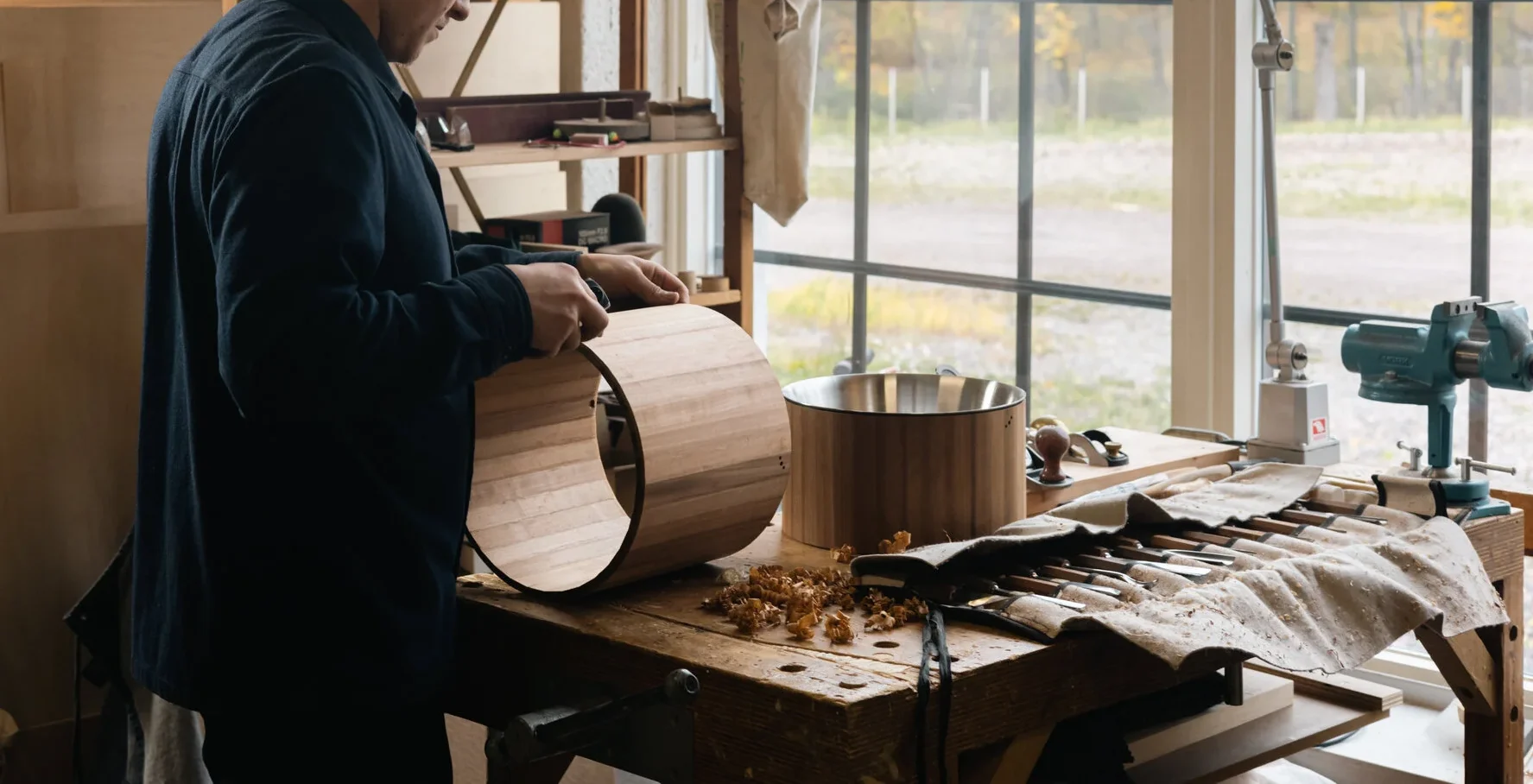 Craftsman handcrafting wooden furniture in a workshop using traditional woodworking tools for outdoor furniture design
