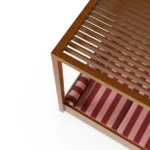 Detailed view from above of the Paraggi sunbed by Mediterrazza, focusing on the texture of the striped cushions and the refined finish of the iroko wood frame.