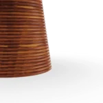 Close-up of the sculptural pedestal base, highlighting the intricate horizontally ribbed iroko wood and its artisanal texture.