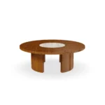 Volpe outdoor table by Mediterrazza, handmade in iroko wood with a travertine top and a base featuring intricate sun-inspired textures.