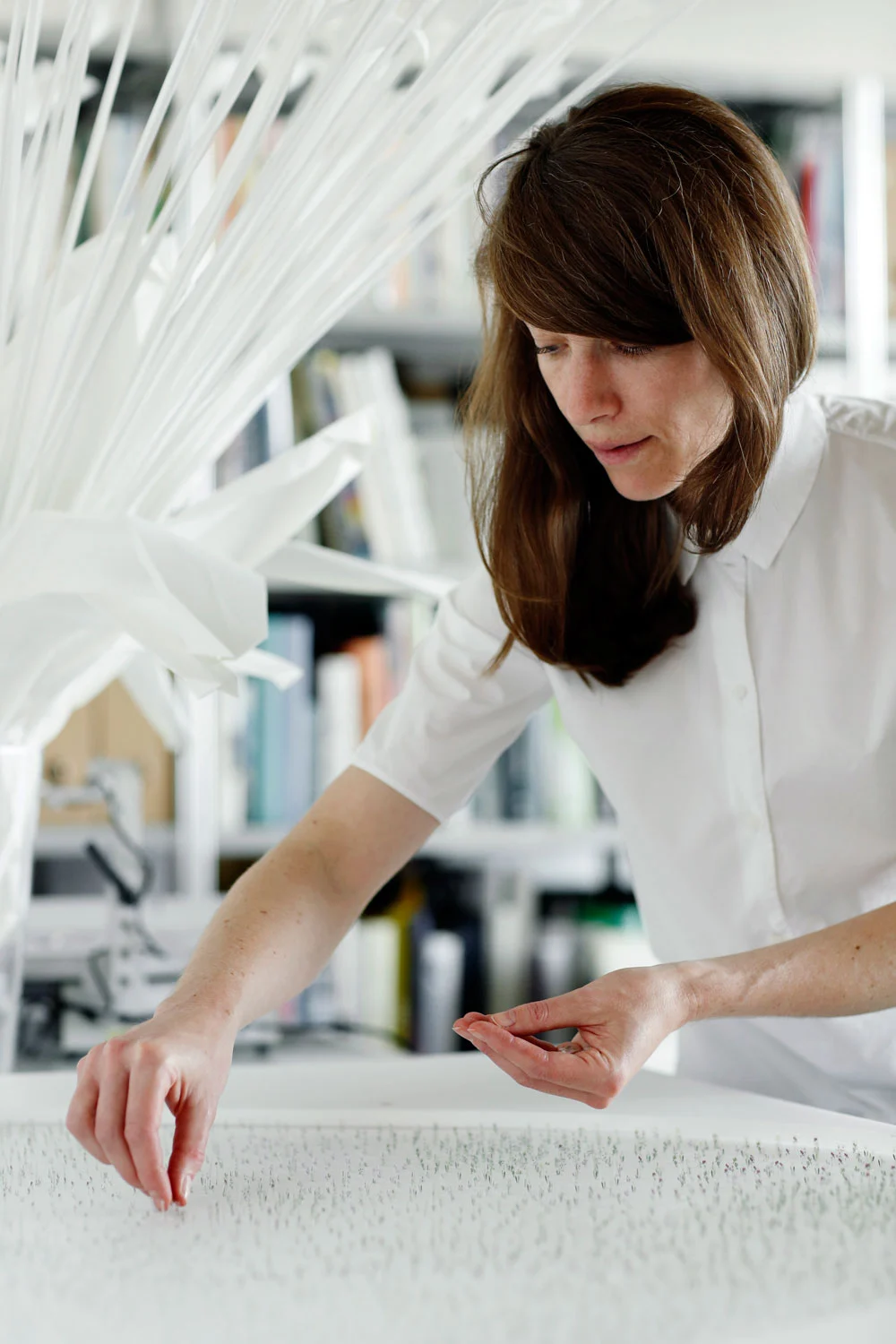 Landscape architect Anouk Vogel working on a detailed model of her garden art installation.