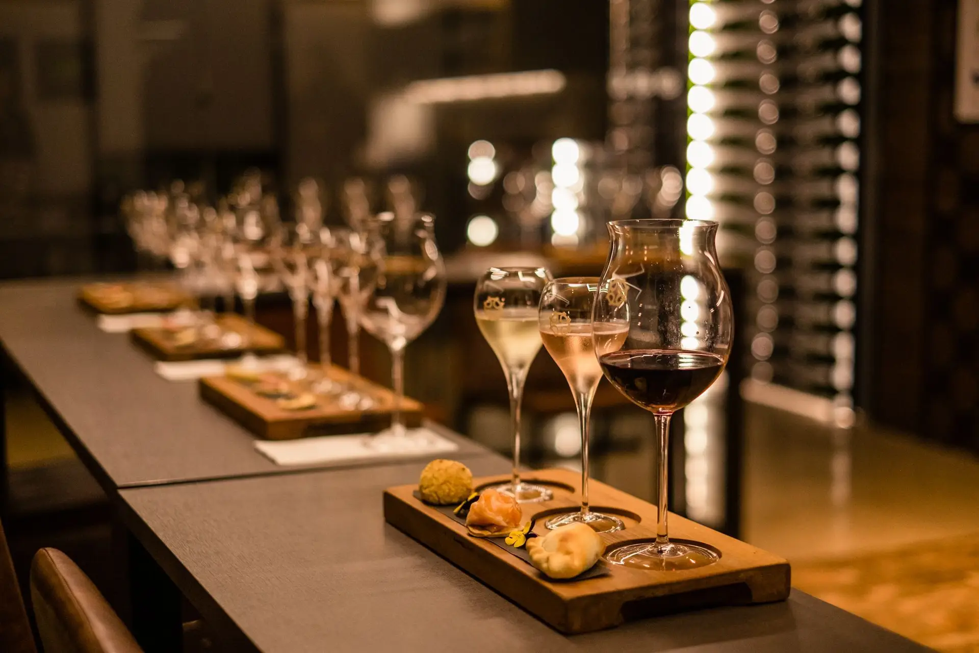 Luxury wine tasting experience with gourmet food pairings served on elegant wooden trays.