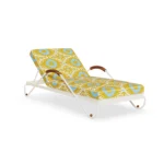 Savona sunbed by Mediterrazza in lacquered metal, displaying vibrant Ikat-patterned cushions and warm iroko wood accents.