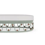 A close look at the Toulon base, focusing on the iroko wood decorative spheres and the smooth, wave-inspired metalwork.