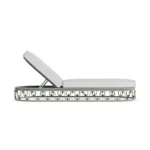 Side profile of the Toulon sunbed, illustrating the unique arched silhouette and the sophisticated Mediterranean aesthetic.