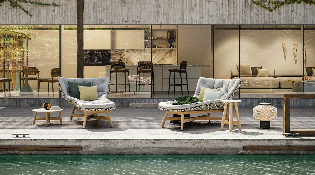 Contemporary poolside lounge with sculptural outdoor armchairs and teak accents overlooking a modern Miami residence.