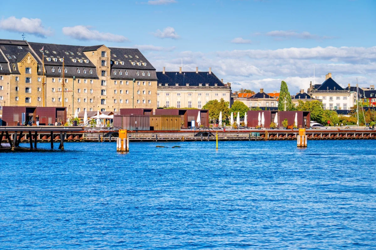 Copenhagen waterfront with contemporary outdoor seating and harbor views, reflecting Scandinavian urban outdoor living and climate-responsive design.