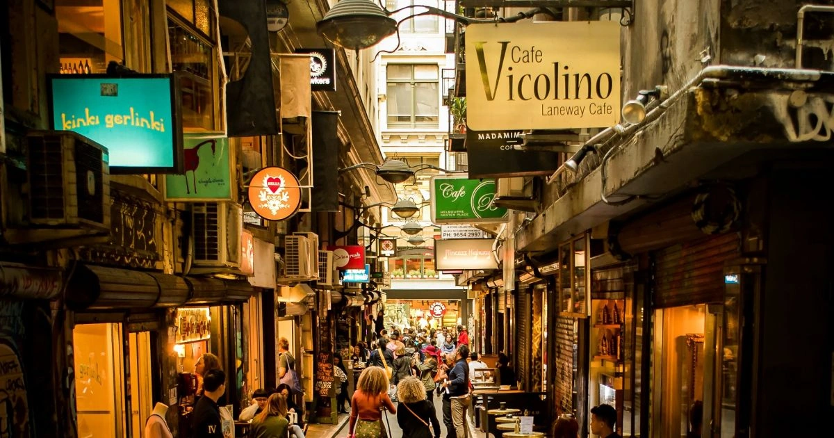 Melbourne laneway animated by cafés and pedestrians, illustrating urban outdoor living culture and intimate street-level social spaces.