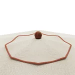 Close-up of the Elba parasol by Mediterrazza, showing the textured beige textile canopy with decorative piping and central wood finial.