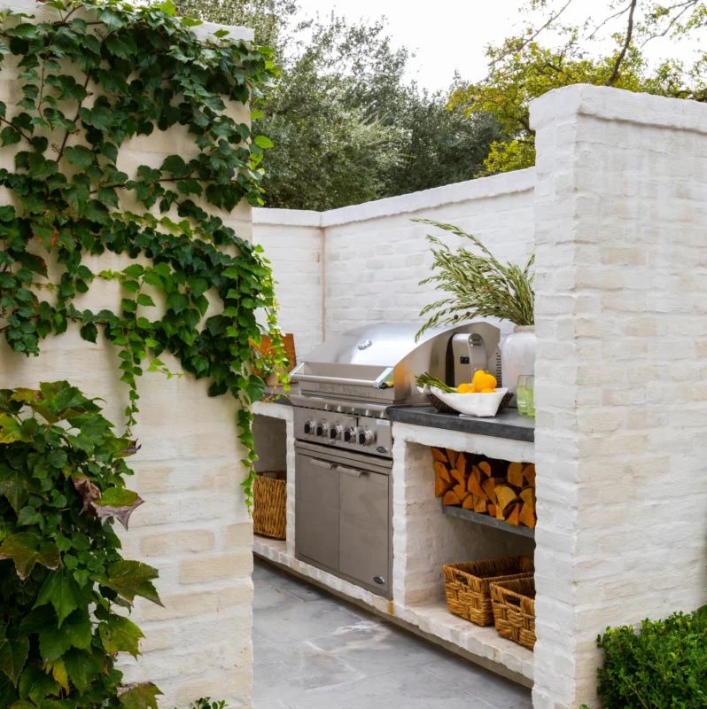 Luxury villas in Spain along the Costa del Sol featuring architecturally integrated outdoor kitchens, panoramic Mediterranean terraces, premium stone and stainless steel finishes, resort-style pergolas, and elegant alfresco entertaining spaces at sunset and night.