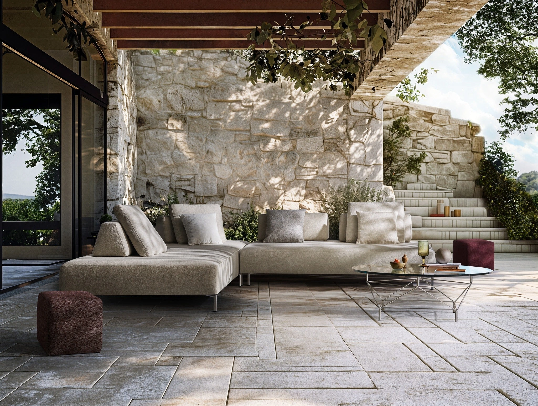 Contemporary modular outdoor sofa in neutral tones set within a refined stone courtyard, reflecting modern outdoor design trends.