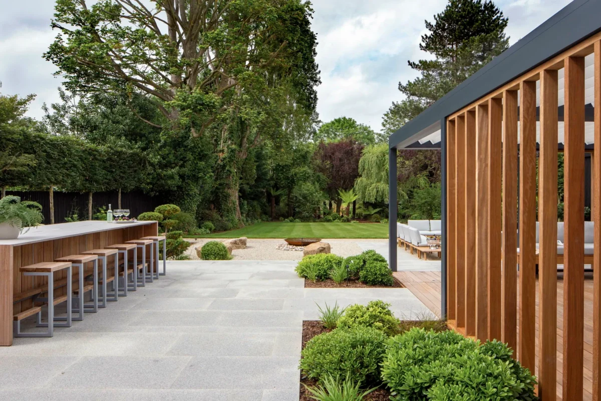 Luxury plant-to-plate outdoor dining experience featuring a refined outdoor dining area set beside a productive kitchen garden, architectural landscaping, and chef-prepared cuisine in an elegant residential setting.