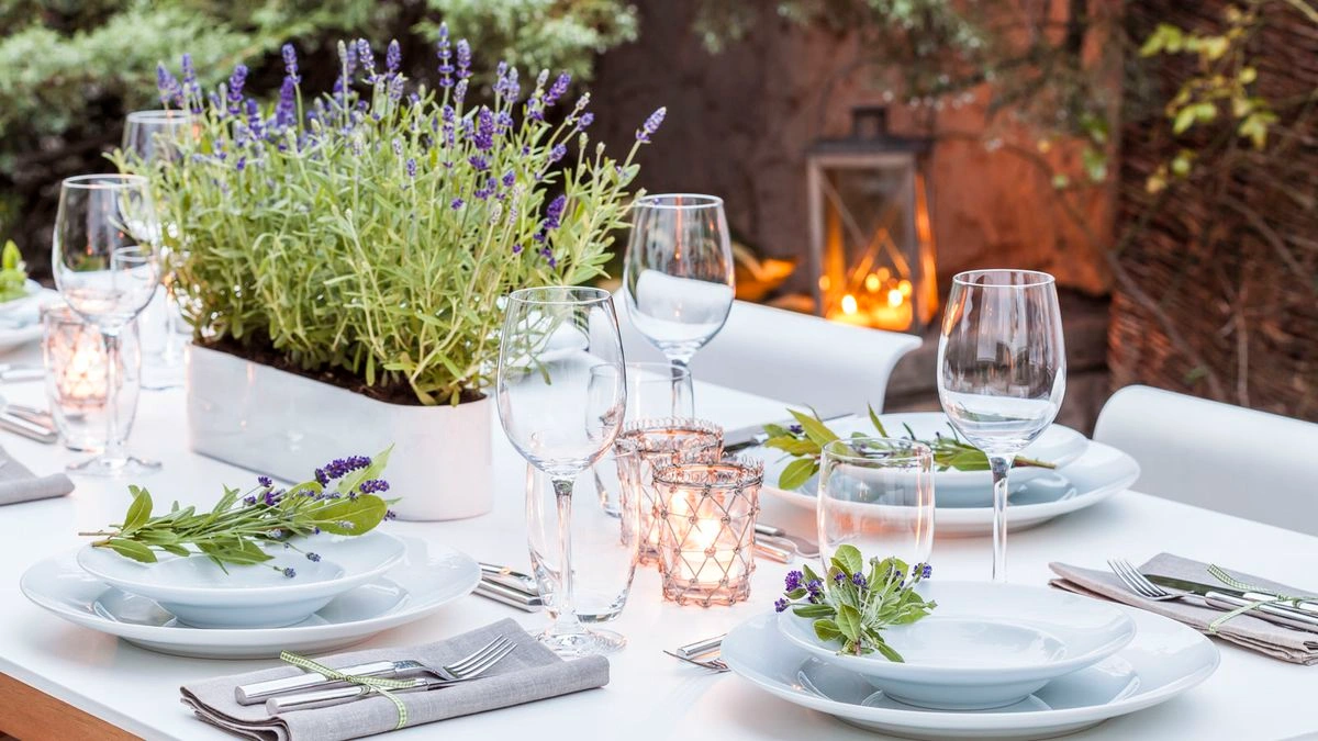 Luxury plant-to-plate outdoor dining experience featuring a refined outdoor dining area set beside a productive kitchen garden, architectural landscaping, and chef-prepared cuisine in an elegant residential setting.