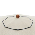 Salerno Parasol by Mediterrazza in textured fabric and iroko wood, vintage outdoor shade with bold navy piping and sculptural timber finial.