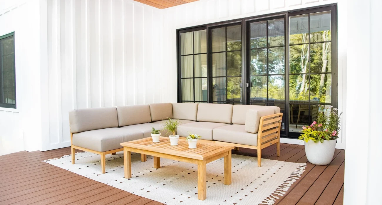 Luxury teak outdoor furniture including lounge seating, dining table, and sectional sofas styled on contemporary oceanfront terraces and poolside decks, showcasing natural wood tones and refined coastal architecture.