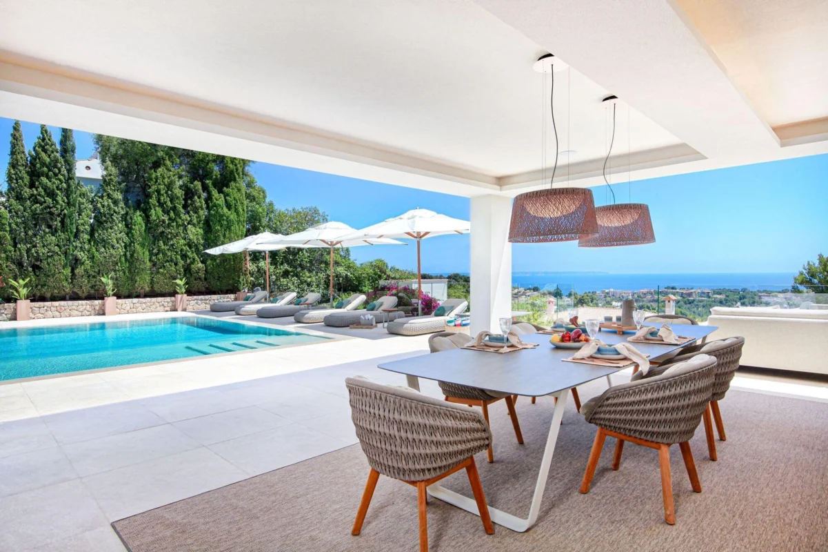 Sculptural contemporary outdoor furniture with soft, organic forms set within a refined natural landscape, expressing luxury outdoor living through fluid design, tactile materials, and seamless integration with architecture and greenery