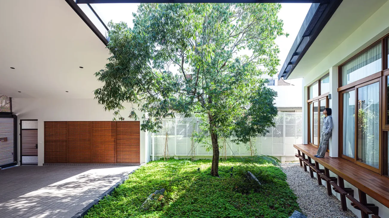 Japanese courtyard house showcasing traditional Japanese architecture with minimalist interiors, sliding shoji screens, wooden engawa veranda, and a serene Zen garden courtyard open to nature.