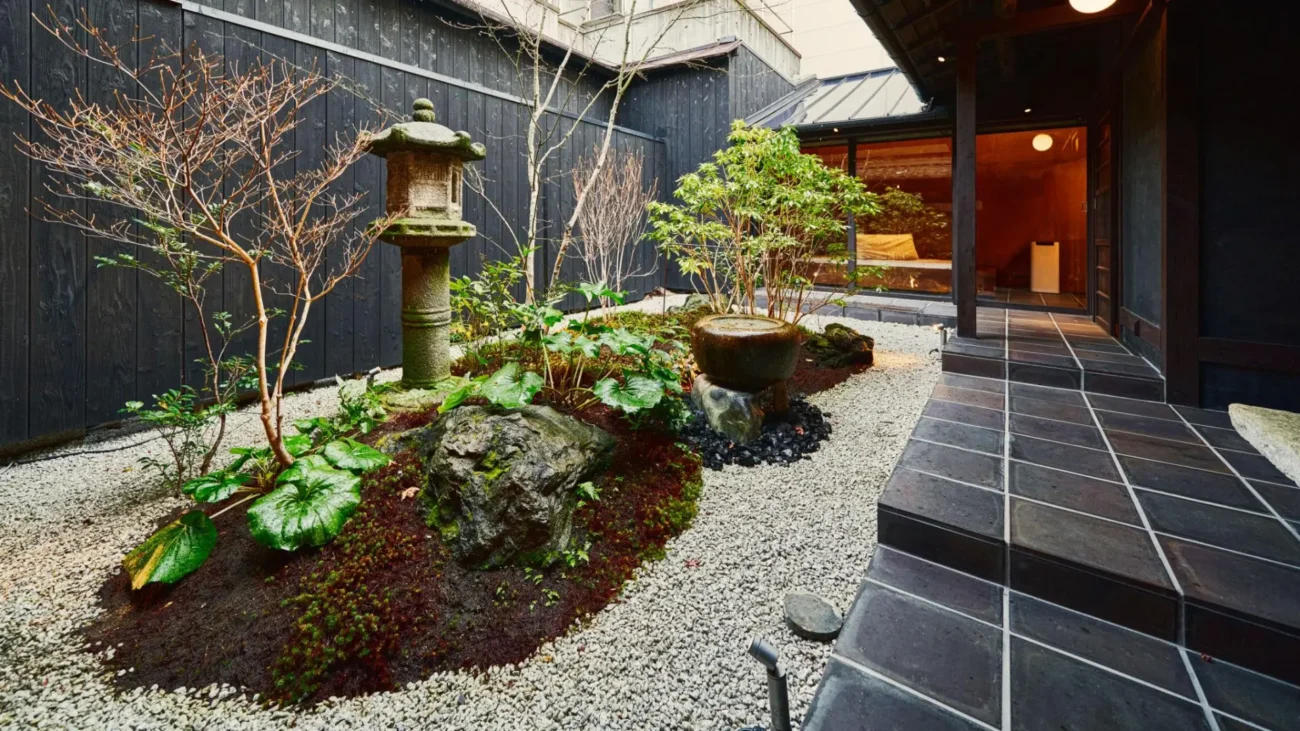 Japanese courtyard house showcasing traditional Japanese architecture with minimalist interiors, sliding shoji screens, wooden engawa veranda, and a serene Zen garden courtyard open to nature.