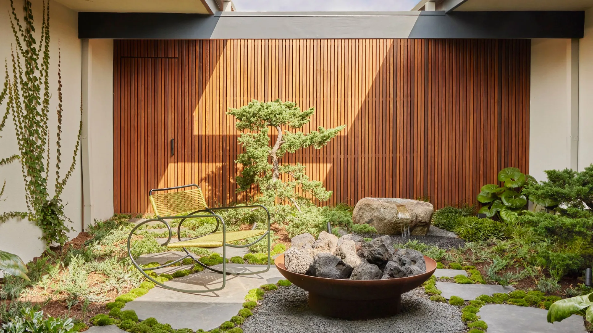 Japanese courtyard house showcasing traditional Japanese architecture with minimalist interiors, sliding shoji screens, wooden engawa veranda, and a serene Zen garden courtyard open to nature.