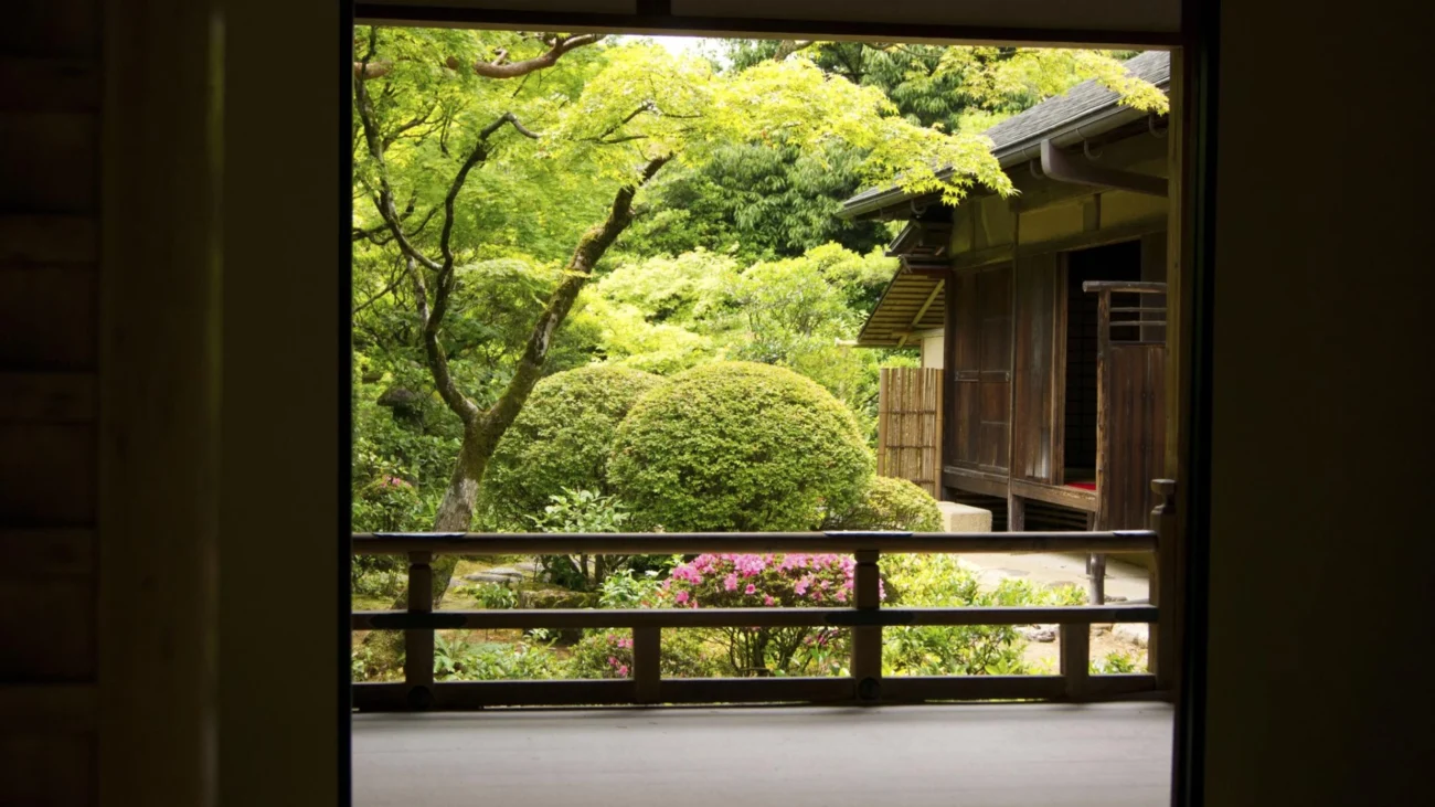 Japanese courtyard house showcasing traditional Japanese architecture with minimalist interiors, sliding shoji screens, wooden engawa veranda, and a serene Zen garden courtyard open to nature.