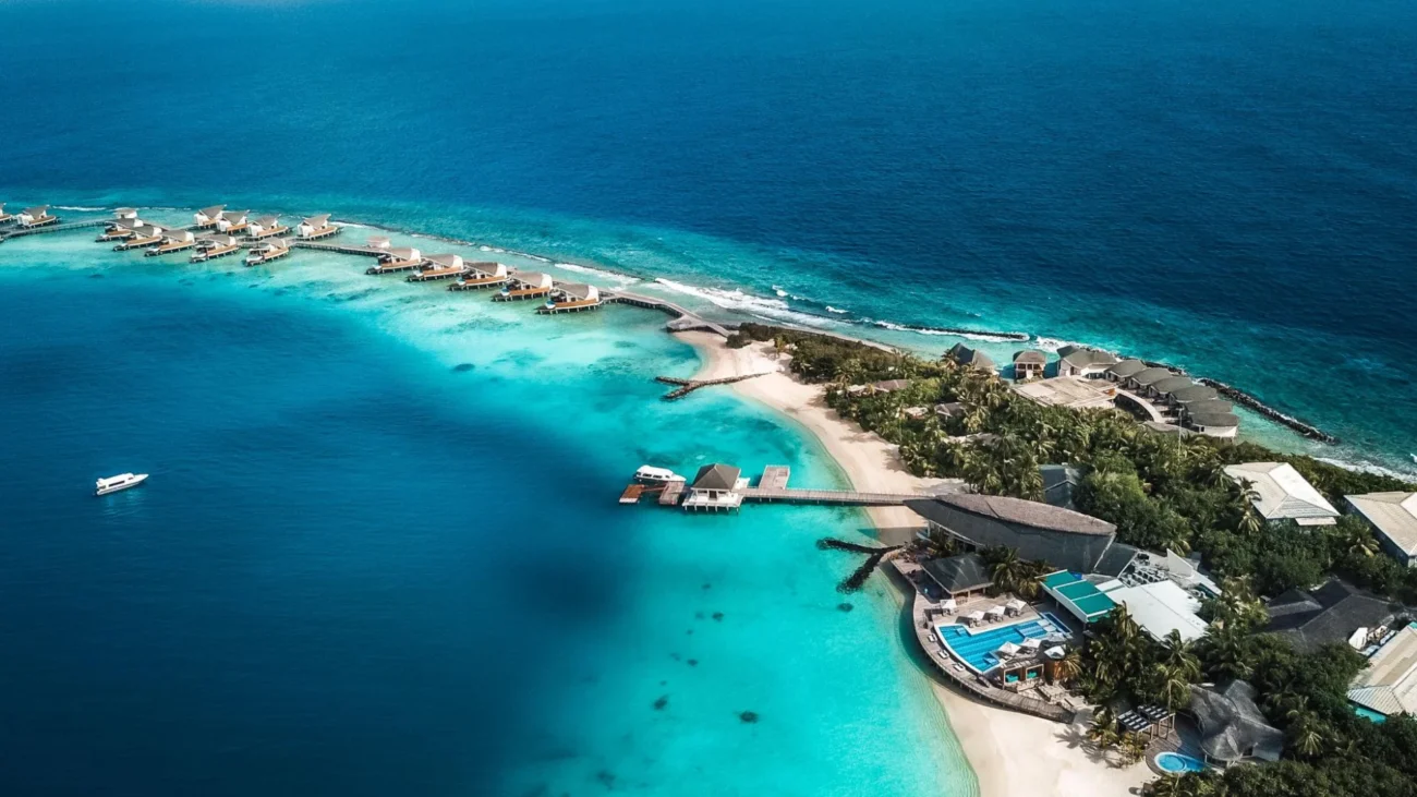 Maldives Island Resorts with luxury overwater bungalow architecture and outdoor lounging terraces above turquoise lagoons