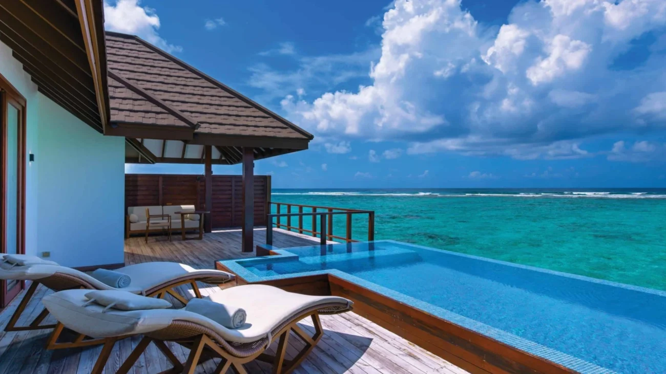 Maldives Island Resorts with luxury overwater bungalow architecture and outdoor lounging terraces above turquoise lagoons