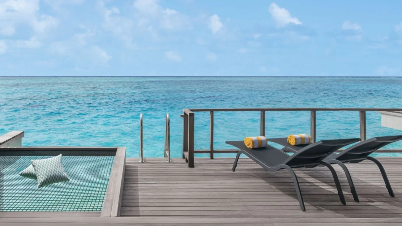 Maldives Island Resorts with luxury overwater bungalow architecture and outdoor lounging terraces above turquoise lagoons
