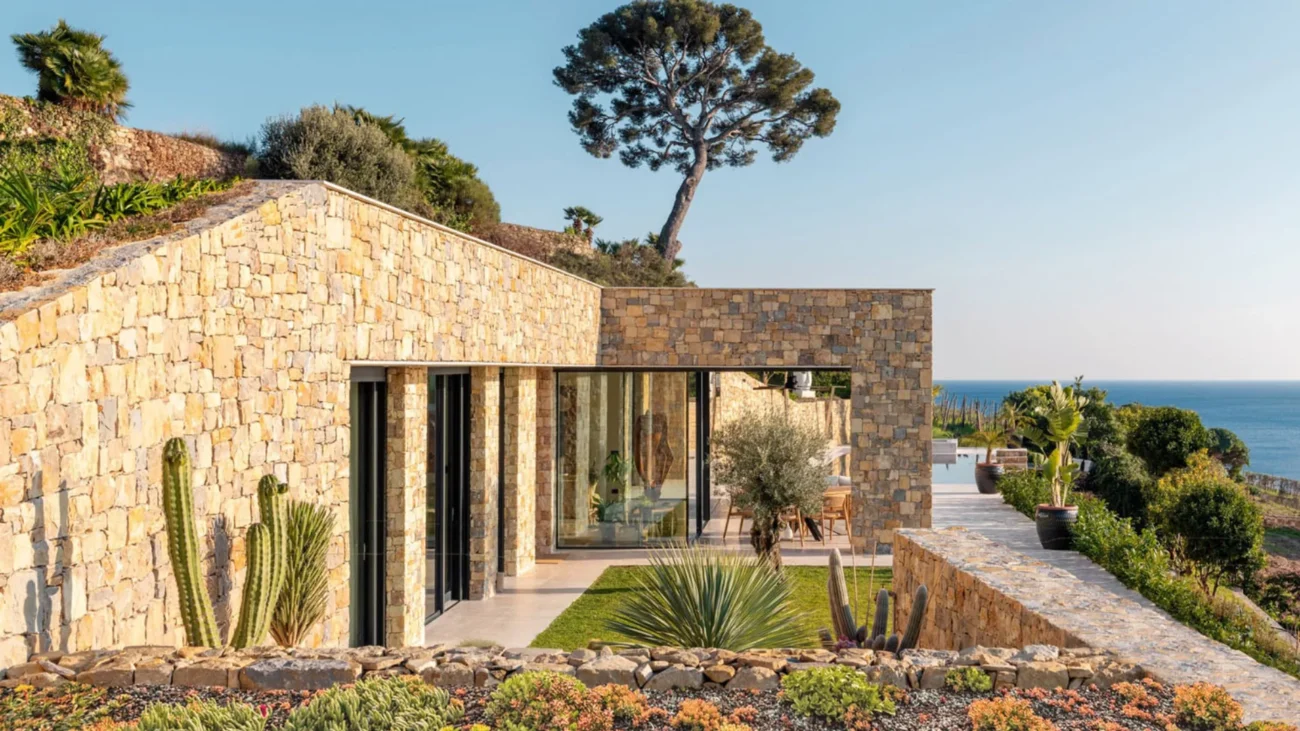 Mediterranean summer house architecture with sea views, natural stone materials, and elegant outdoor living spaces reflecting coastal luxury homes and the Mediterranean lifestyle.