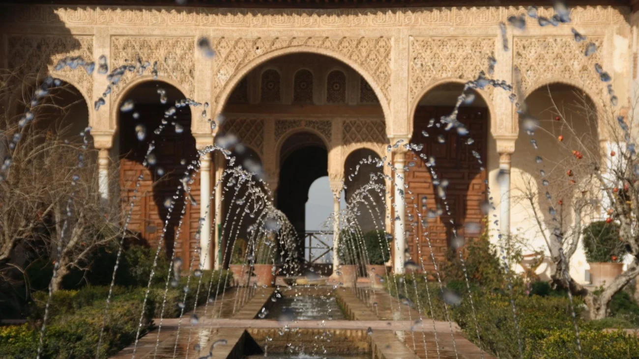 Mediterranean courtyard garden with elegant stone fountain, lush greenery, and traditional architectural details creating a tranquil water feature centerpiece.
