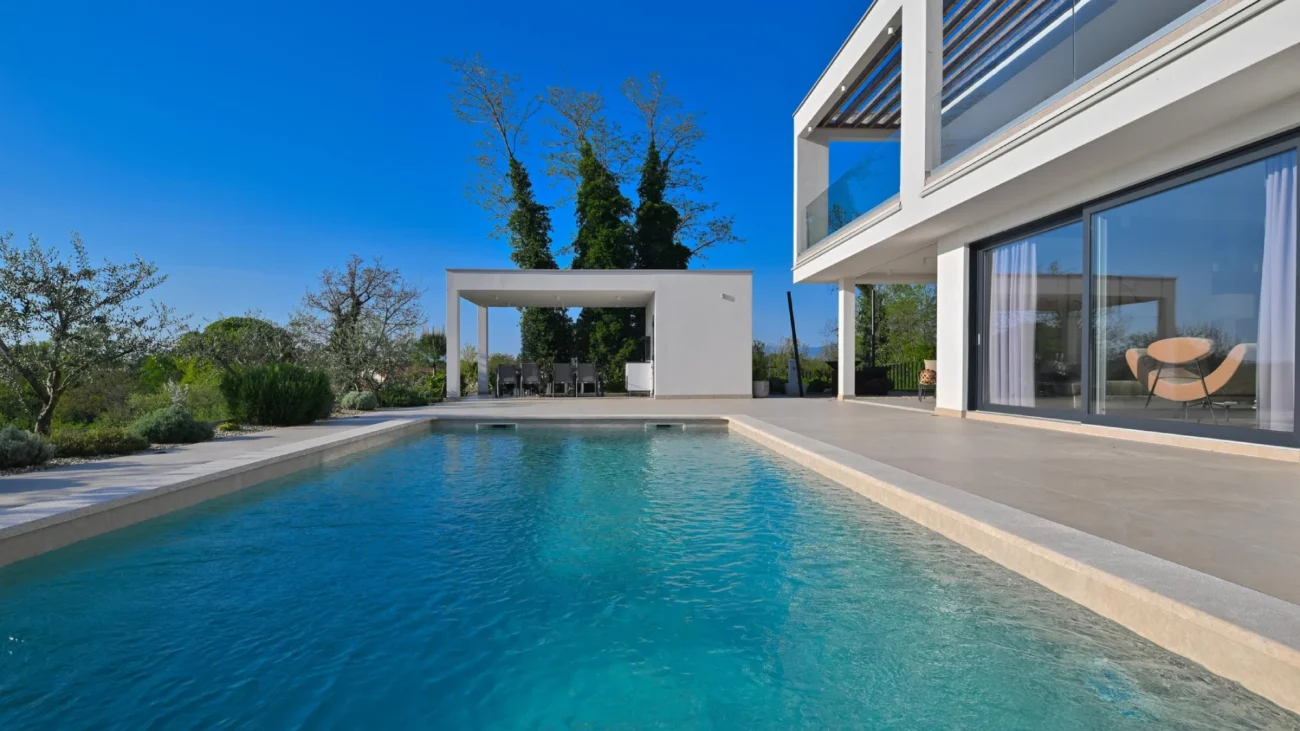 Mediterranean courtyard garden with elegant stone fountain, lush greenery, and traditional architectural details creating a tranquil water feature centerpiece.
