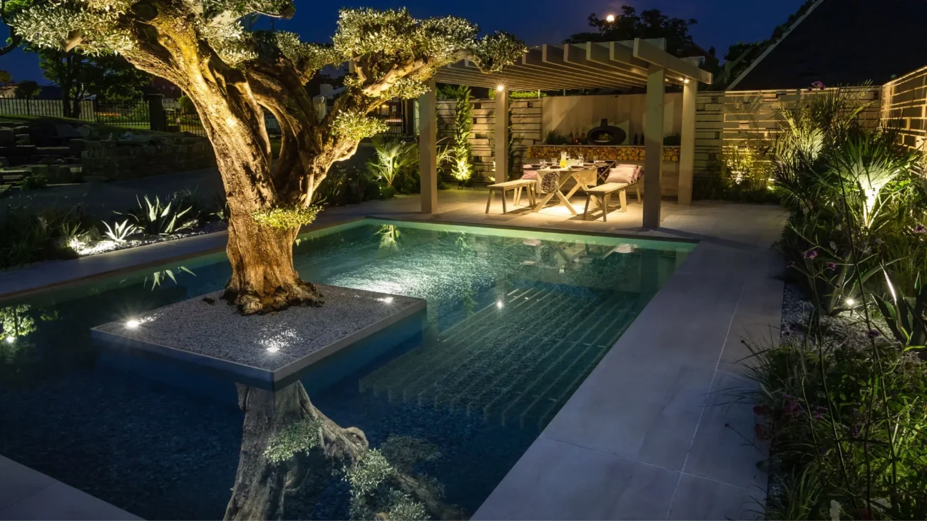 Mediterranean courtyard garden with elegant stone fountain, lush greenery, and traditional architectural details creating a tranquil water feature centerpiece.