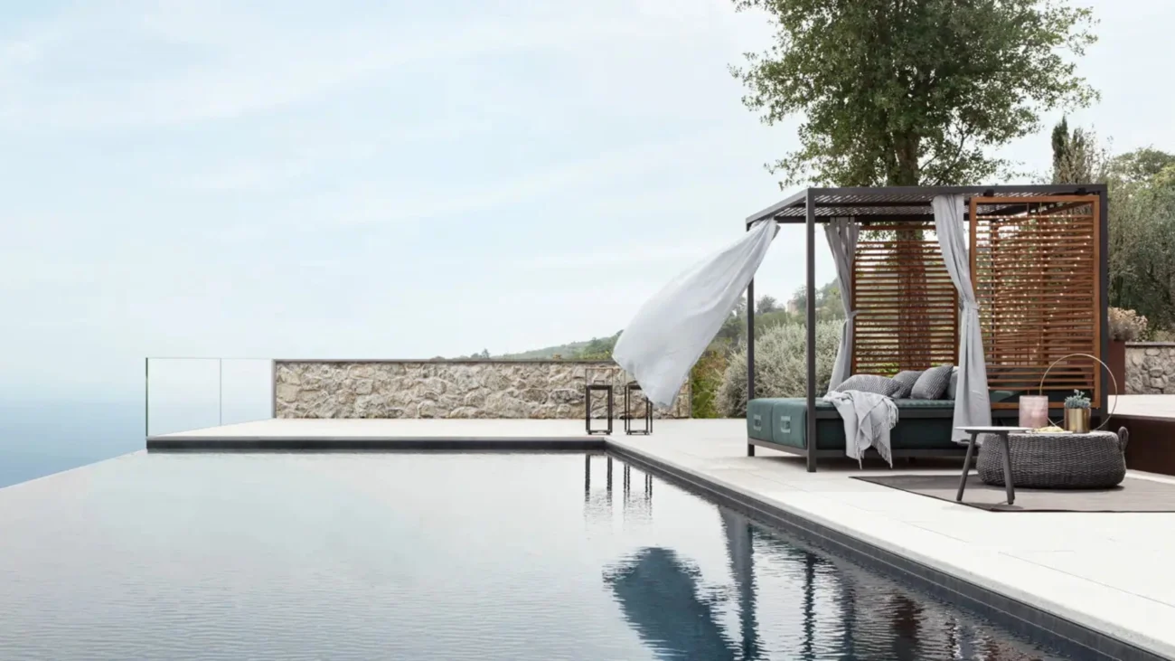 Luxury outdoor daybeds on Mediterranean terraces and Caribbean beachfront villas showcasing high-end outdoor living and contemporary coastal furniture design.