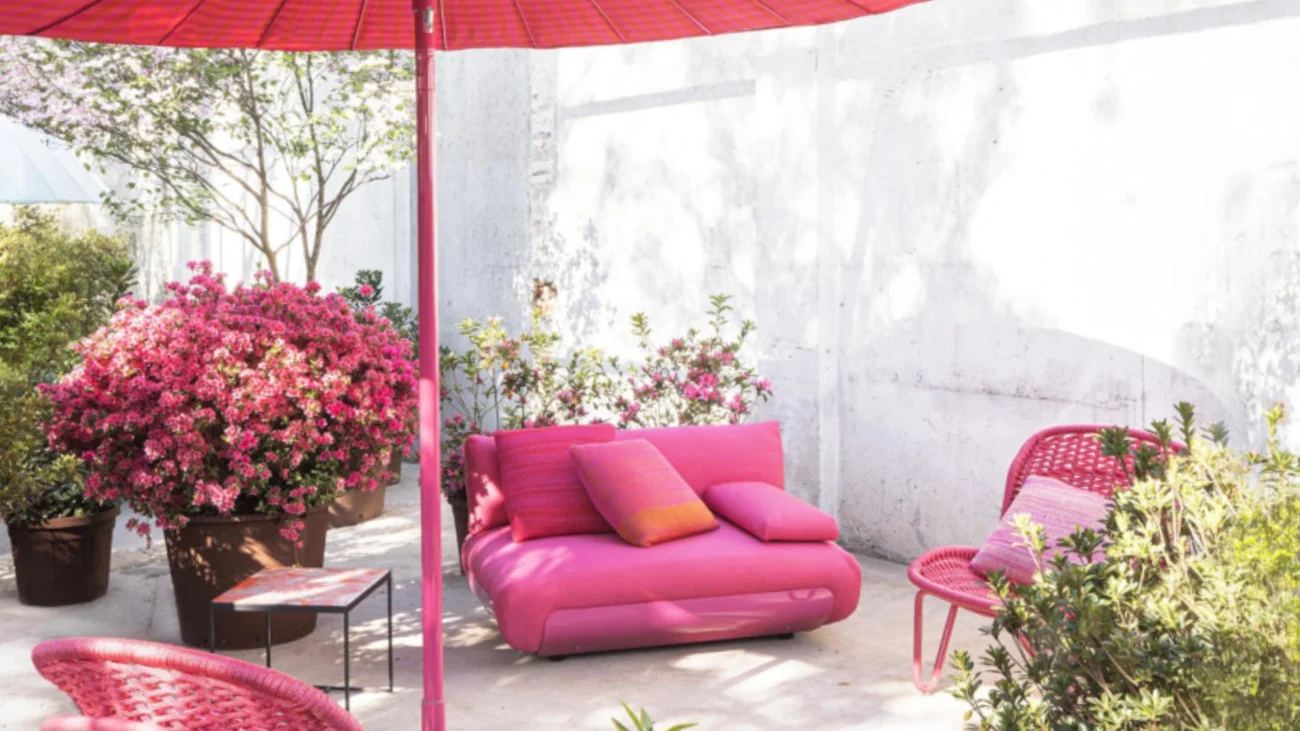 Colorful Paola Lenti luxury outdoor furniture on a Mediterranean terrace showcasing vibrant textiles, woven textures, and contemporary outdoor design.