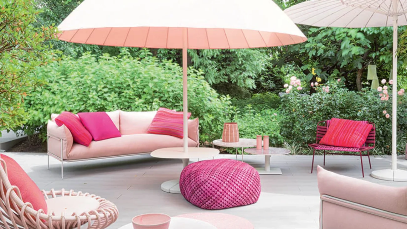 Colorful Paola Lenti luxury outdoor furniture on a Mediterranean terrace showcasing vibrant textiles, woven textures, and contemporary outdoor design.