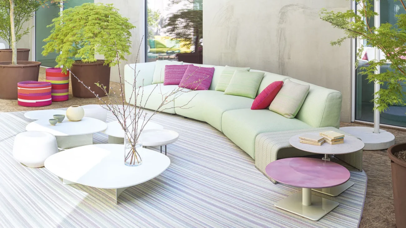 Colorful Paola Lenti luxury outdoor furniture on a Mediterranean terrace showcasing vibrant textiles, woven textures, and contemporary outdoor design.