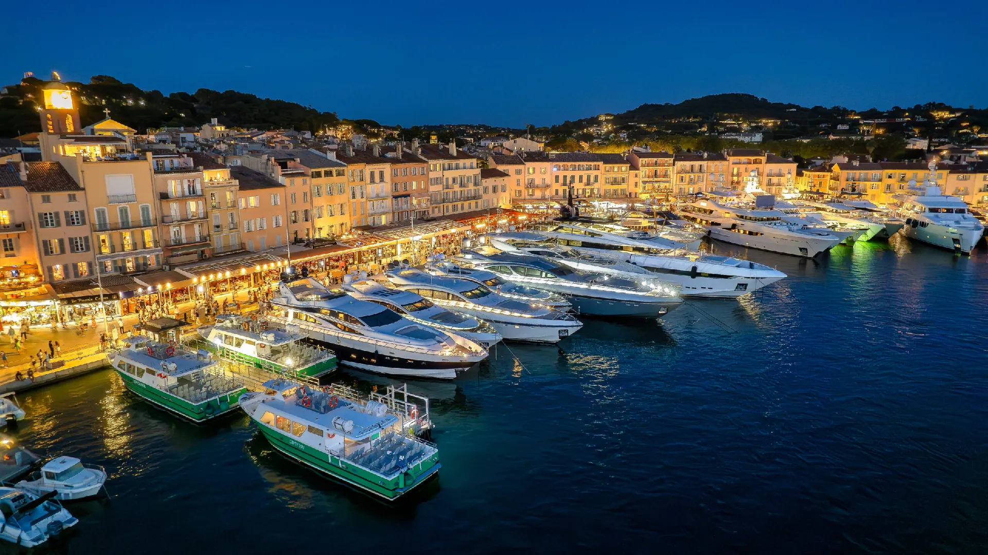 Elegant terraces in Saint-Tropez harbor apartments overlooking the Vieux Port with Mediterranean outdoor furniture and Riviera views.
