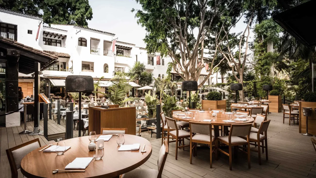 Luxury outdoor dining terrace at a Marbella beachfront restaurant showcasing elegant Mediterranean design, sea views, and refined alfresco atmosphere.