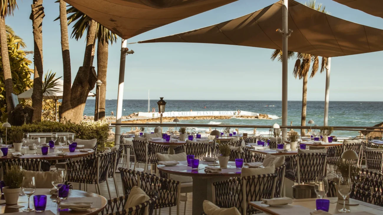Luxury outdoor dining terrace at a Marbella beachfront restaurant showcasing elegant Mediterranean design, sea views, and refined alfresco atmosphere.