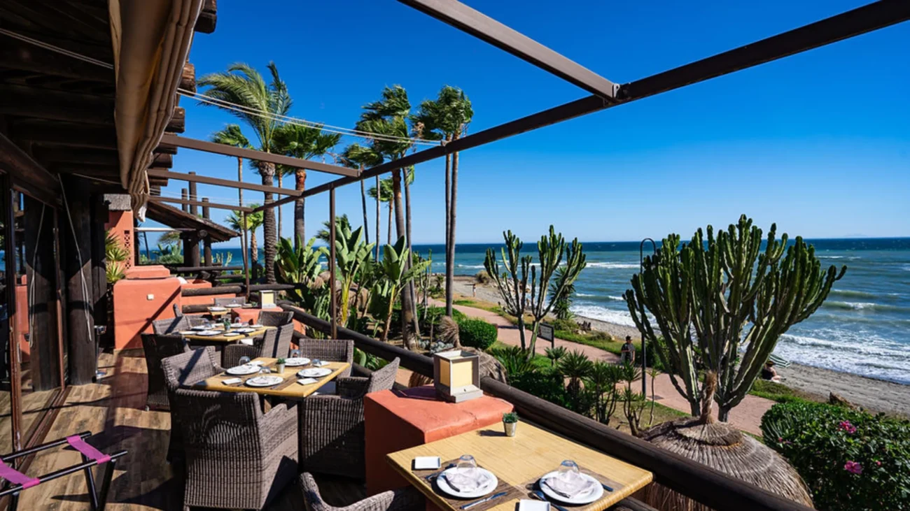 Luxury outdoor dining terrace at a Marbella beachfront restaurant showcasing elegant Mediterranean design, sea views, and refined alfresco atmosphere.