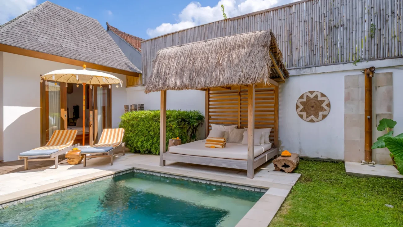 Tropical Bali villa with open living design, outdoor lounge pavilion, infinity pool and jungle landscape